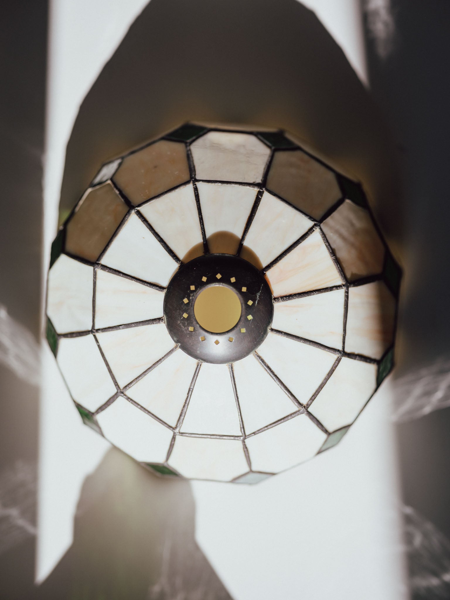 Decorative stained glass light fixture with a geometric pattern.