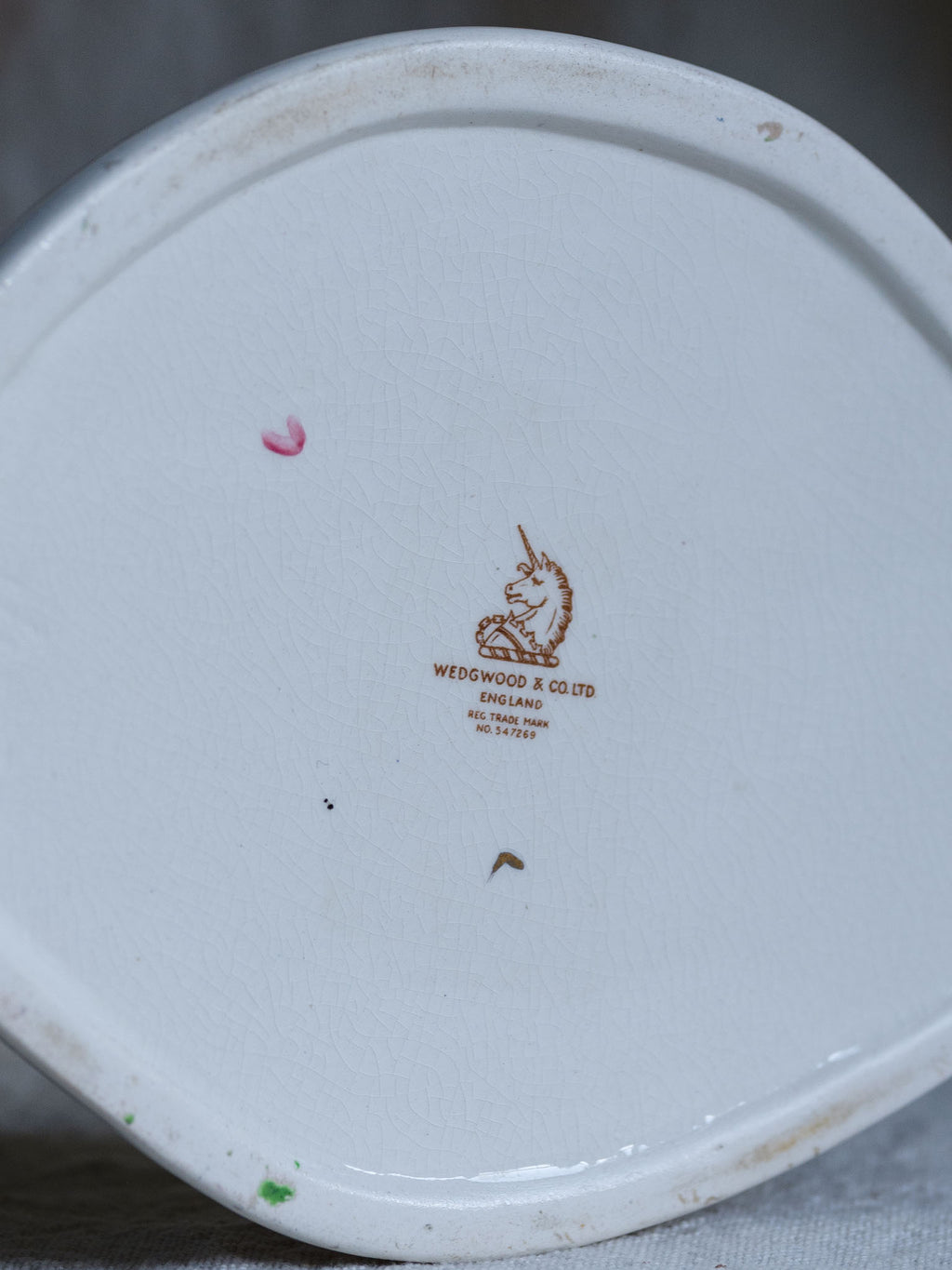 Wedgewood logo on a ceramic plate with a gray background