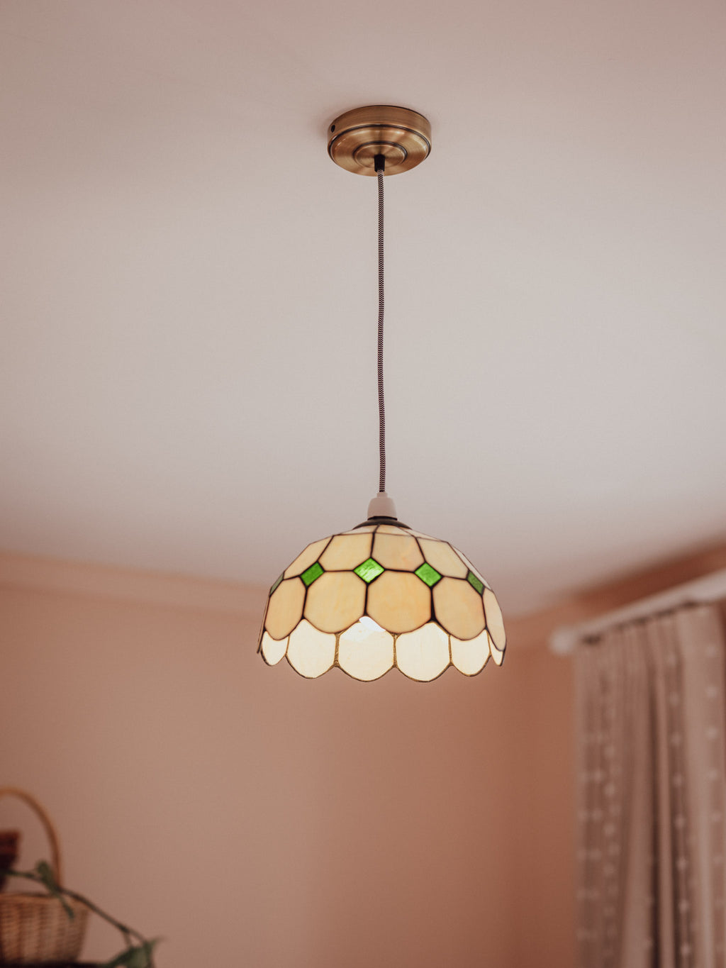 Tiffany-style pendant light with stained glass shade in a room setting