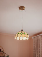 Tiffany-style pendant light with stained glass shade in a room setting