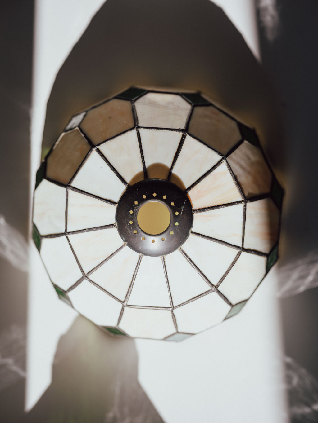 Decorative stained glass light fixture with a geometric pattern.