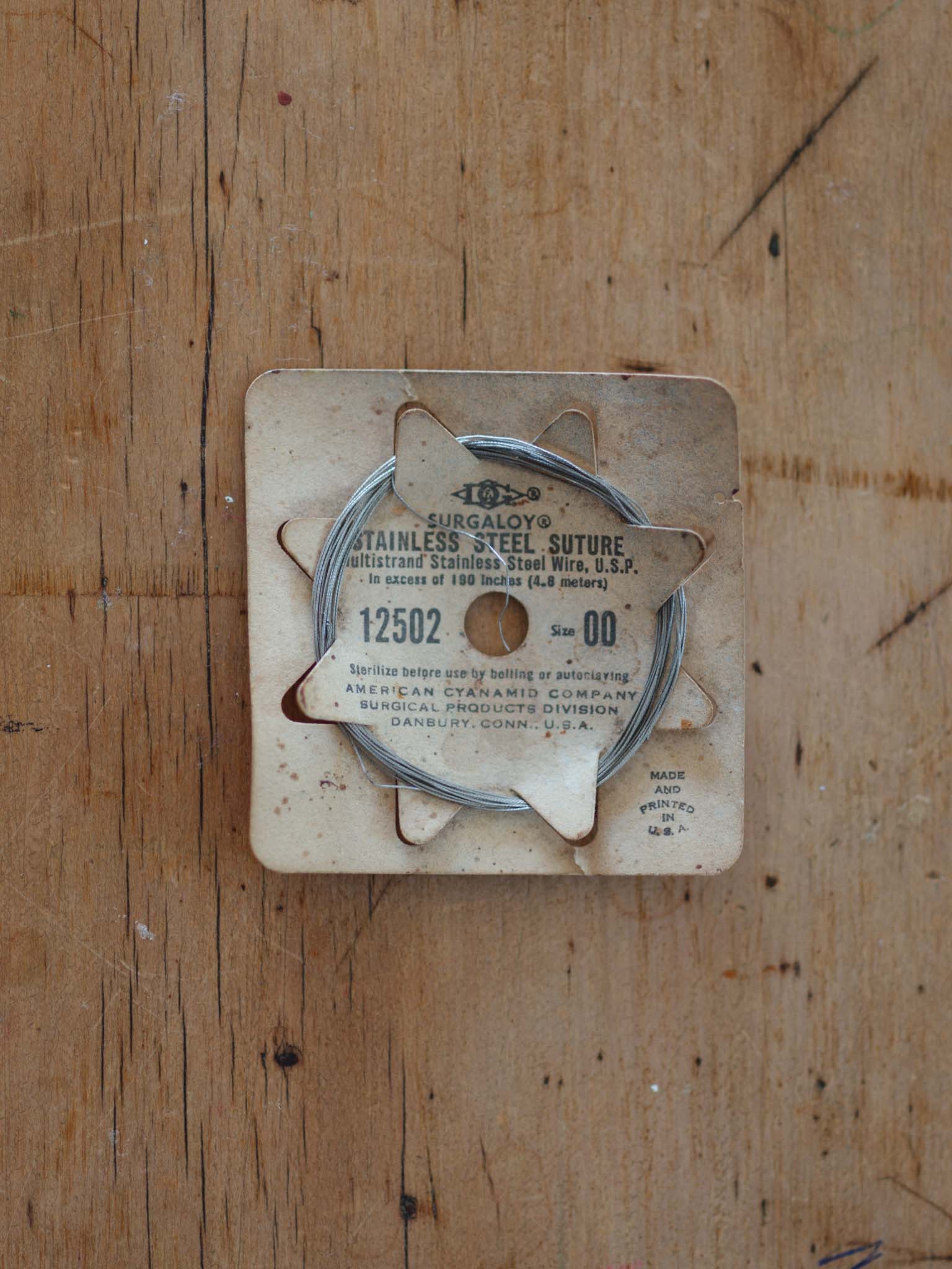 Antique stainless steel suture - original packaging