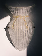 Vintage Murano glass wall sconce with ribbed clear glass and gold ribbon detailing. Italian mid-century wall light, hand-blown using the Graniglia technique. Mounted on a light grey backplate with brass fittings, perfect for hallways, bedrooms, or statement lighting.